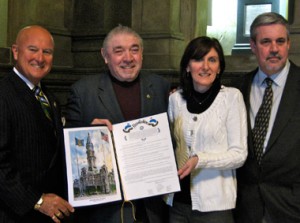 Liz and Pearse Kerr, at right, with Pennsylvania Supreme Court Justice Seamus McCaffrey at far left, and AOH National President Seamus Boyle with the city council resolution. Photo by Sarah Emenheister.