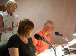 From last August's WTMR radio on-air fundraiser, St. Patrick's Day Parade Director Michael Bradley joins host Marianne MacDonald at the microphone. Volunteer Olivia Hilpl is at left. 