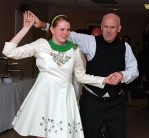 Father Ed Brady picks up a few steps from one of the Timoney Dancers. 