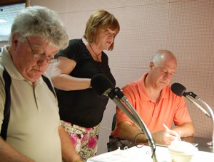 Going over pledge drive strategy are, from left, radio hosts Vince Gallagher and Marianne MacDonald, and St. Patrick's Day parade director Michael Bradley.