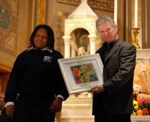 Musician Billy McComiskey shows off the art work presented to each of the musicians.