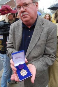 Nephew John Boyle displays Donnelly's medal of valor.