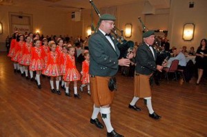 The Emerald Pipe Band ushers in the dancers.