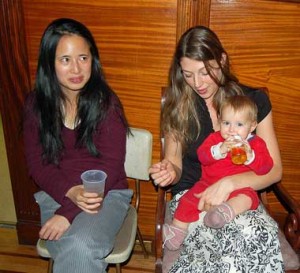 Fiddlers Dana Lyn and Athena Tergis share post-show refreshments with Tergis's daughter Vivienne.