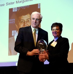 Irish Ambassador Michael Collins presents the award to Sister Marguerite O’Beirne on Neumann.